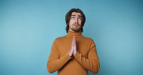 Footage of young man with a thoughtful expression holds his hands together .. Stock Footage 314522121