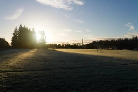 Footbal field with bridge in the bacground while sunrise Stock Photos