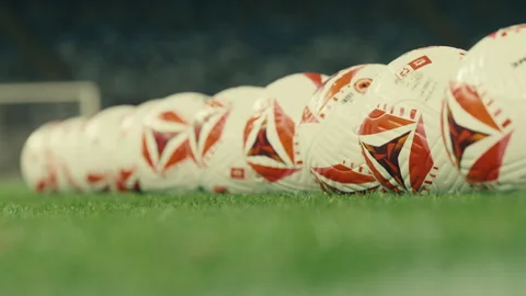 Football Balls Lined Up on Stadium Field Stock Footage 329051908