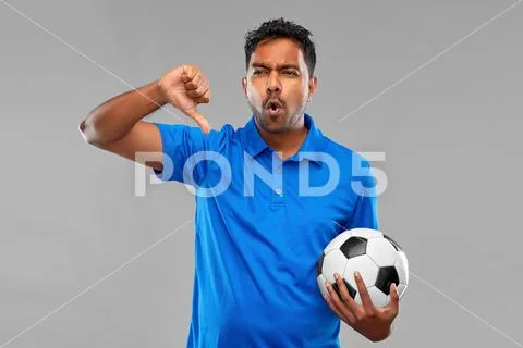 Football fan with soccer ball showing thumbs down Stock Photos