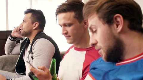 Football fans using mobile phone  Stock Footage 85176653