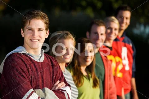 Football: friends ready to play football in park Stock Photos