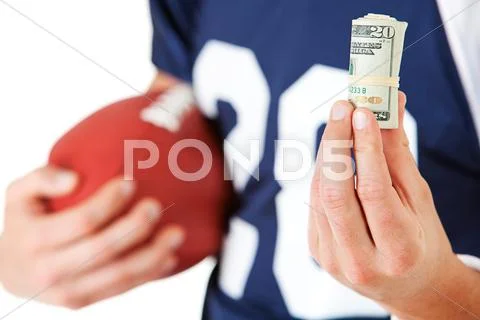 Football: holding a roll of cash Stock Photos