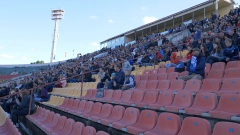Football match  of the belarussian teams.Fans cheer for them in the stands Stock Footage