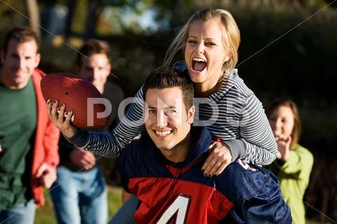 Football: piggyback girl going for touchdown Stock Photos