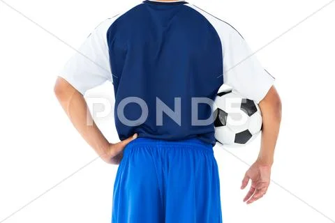 Football player in blue holding ball Stock Photos