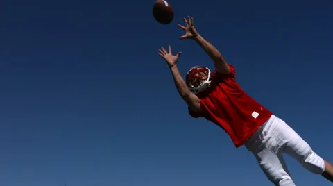 Football player catches ball, slow motion Stock Footage