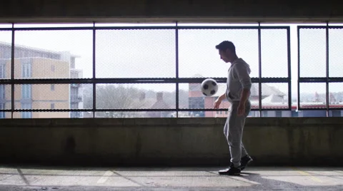 Football player doing fancy kick up tricks with a soccer ball, in slow motion Stock Footage