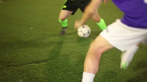 Football player (forward) tricks with a ball in soccer match Stock Footage