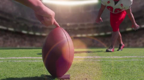 A football player kicks a field goal in a stadium, slow motion close up Stock Footage