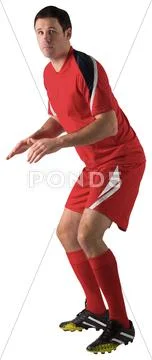 Football player in red standing ready Stock Photos