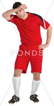 Football player in red wiping his brow Stock Photos
