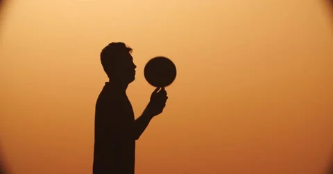 Football player silhouette , practicing with the ball,the sunset Golden hour Stock Footage