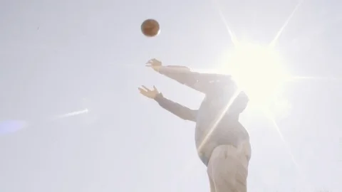 Football player throwing high up, heading ball at athletic field. Slow motion Stock-Footage 76046982