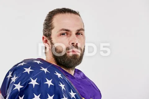 Football Player with uniform and a american flag on his shoulders proud of his Stock Photos