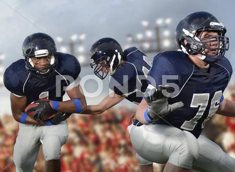 Football players passing ball Stock Photos