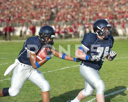 Football players passing ball Stock Photos