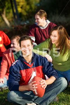 Football: relaxing with friends in park Stock Photos