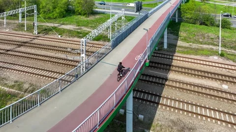 Footbridge with cycle path and biker in Krakow, Poland Stock Footage 242270293