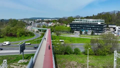Footbridge with cycle path, bikers and electric scooter in Krakow, Poland Stock Footage 271661206