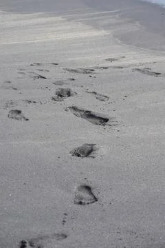 Footmarks on sand at beach Stock Photos