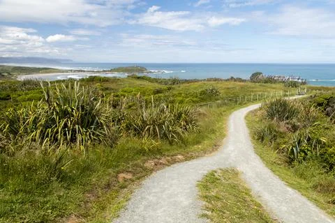 Footpath along the cliffs at Cape Foulwind, New Zealand under blue skies Stock Photos