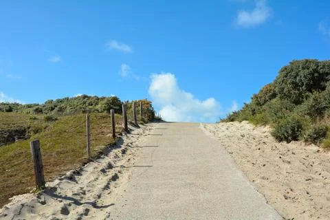 Footpath between the dunes to the beach Stock Photos