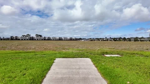 Footpath leads to a large vacant plot of land near new housing developments Vídeos de archivo 308047945