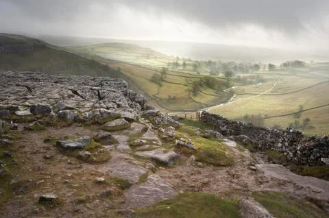 Footpath from limestone pavement down to malham cove in yorkshire dales natio Stock Photos