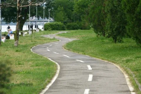 Footpath reached in trees and park Stock Photos