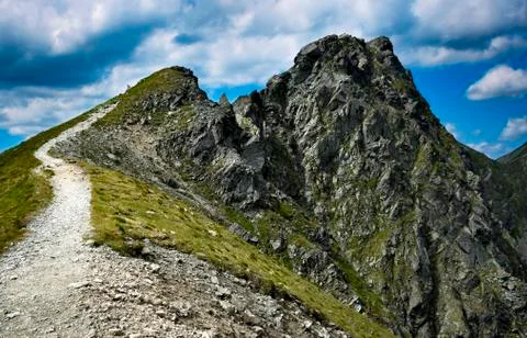 Footpath to a rocky mountain peak with dramatic sky Stock Photos