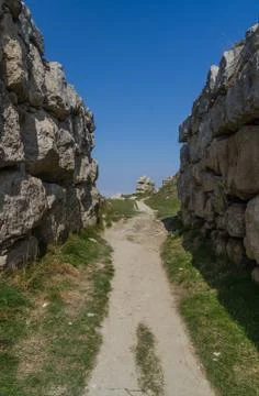 Footpath running between two limestone walls. Stock Photos