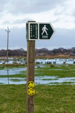 Footpath sign with floods Stock Photos
