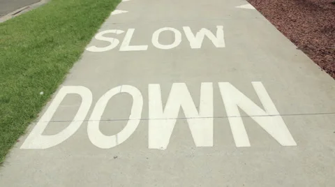Footpath with the words Slow Down Stock Footage 40448656