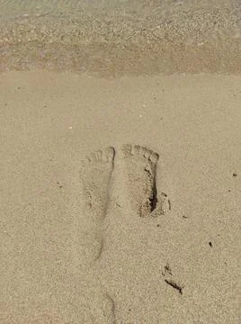 Footprint at beach with waves. Stock-Fotos