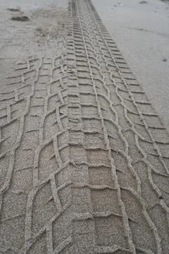 The footprint of a car tire in the sand. Stock Photos