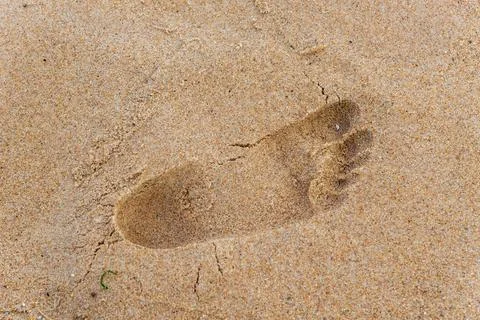 Footprints and shapes in the brown sand of the famous Rio Vermelho beach. Stock Photos