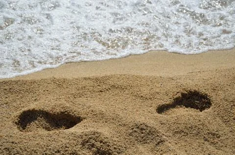 Footprints on beach Stock Photos