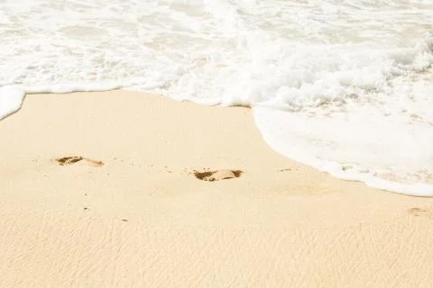 Footprints on beach sand Stock Photos