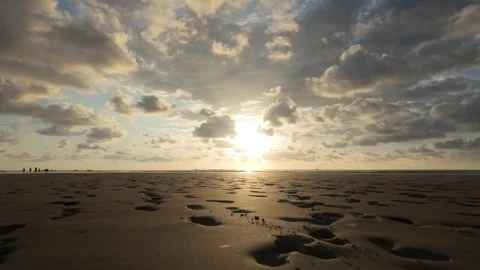 Footprints on the beach at sunset Stock Footage 302692275