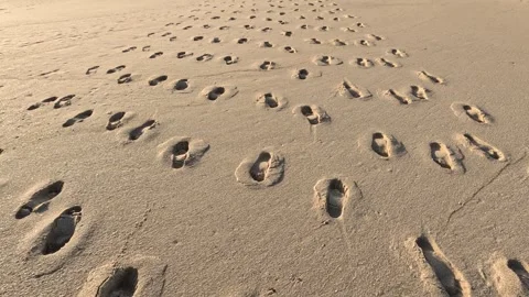  footprints of the humans left on a sandy beach 動画素材 245709897