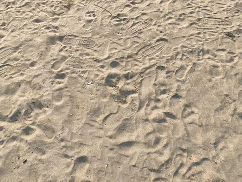 Footprints Left on Sandy Beach Surface Background Stock Photos
