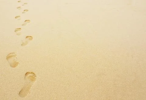Footprints in the sand background Stock Photos