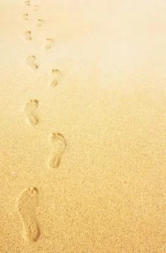 Footprints in the sand background Stock Photos