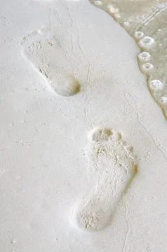 Footprints on sand beach close up Stock Photos
