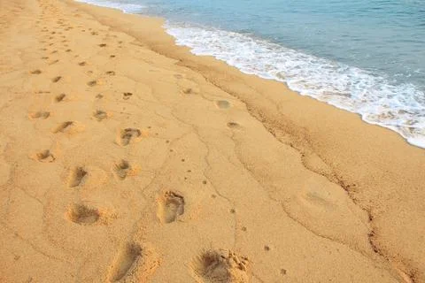 Footprints on the sand beach Stock Photos