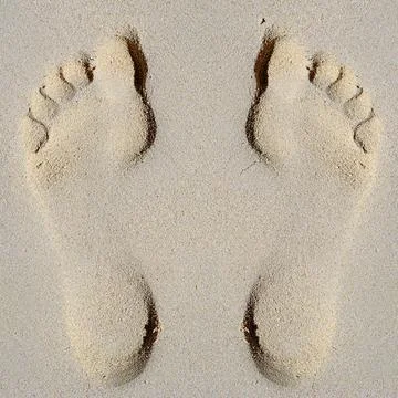 Footprints in sand on beach Stock Photos