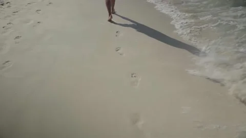The footprints in the sand washed away by the wave of the sea Stock Footage 147176167