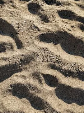 Footprints on Sandy Beach Closeup view of human footprints in soft beach sa.. Stock Photos