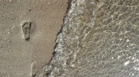 Footprints on the seashore Stock Footage 12271498